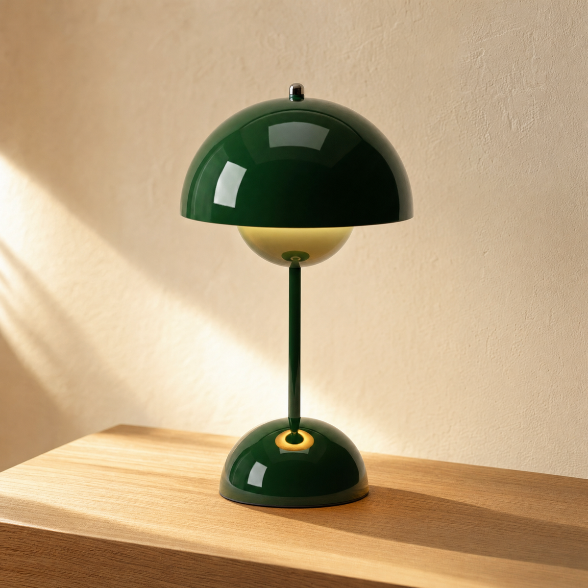 Nimba cordless table lamp in Green on a light oak table